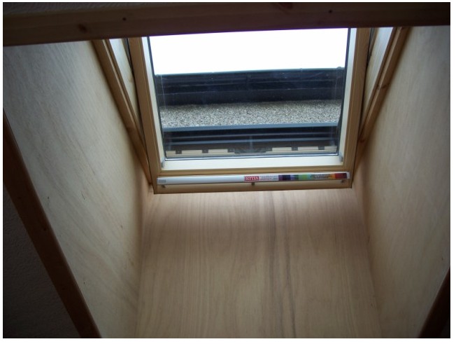 The inside view of a Velux fitted to an upstand on a flat roof.